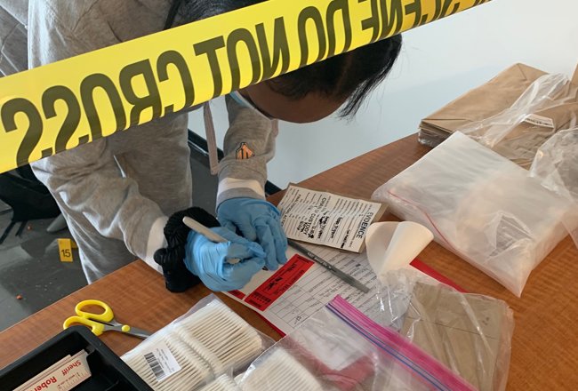Students get a hands-on lesson with forensics at a mock crime scene.