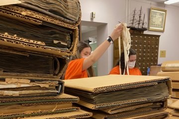 Students help catalog and organize artifacts at the Oneida County History Center as part of Pioneer Pitch-In.